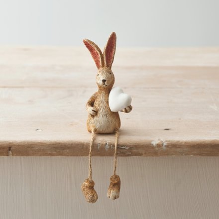 A charming shelf sitting rabbit decoration with jute string dangling legs.