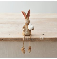 A charming shelf sitting rabbit decoration with jute string dangling legs.