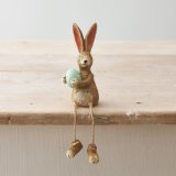 A charming shelf sitting rabbit with jute string dangling legs and a beautifully crafted textured finish.