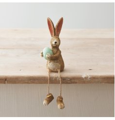 A charming shelf sitting rabbit with jute string dangling legs and a beautifully crafted textured finish.