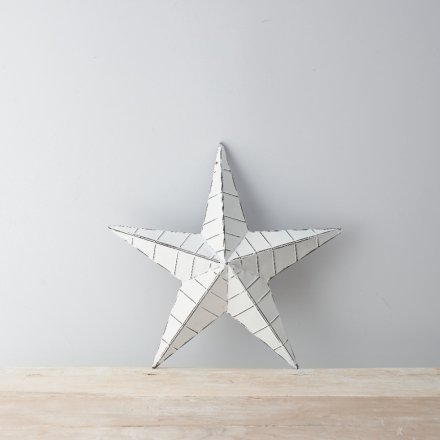 A chic white metal barn star with ridges. A distressed decorative item for the home or garden.