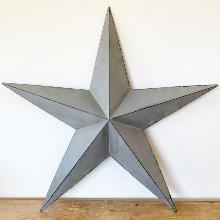 A rustic grey metal barn star with distressed detailing. Perfect for making a statement inside or outside of the home.
