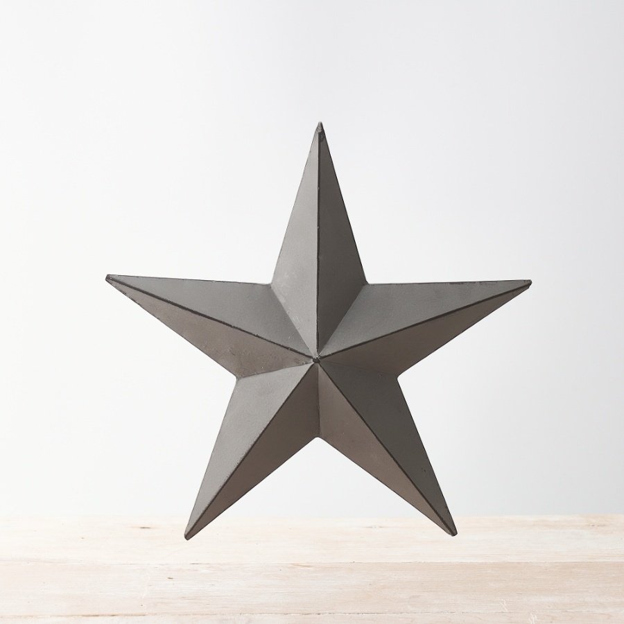 A vintage inspired grey metal barn star with distressed detailing on each three-dimensional point.