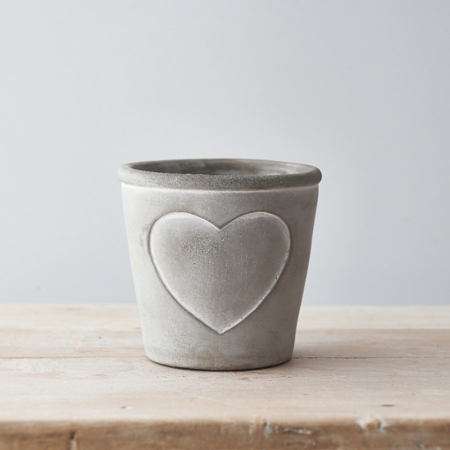 A chic and stylish rustic cement planter with an embossed heart detail. Complete with soft white painted lines.