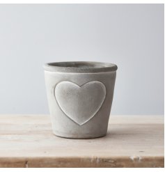 A chic and stylish rustic cement planter with an embossed heart detail. Complete with soft white painted lines.