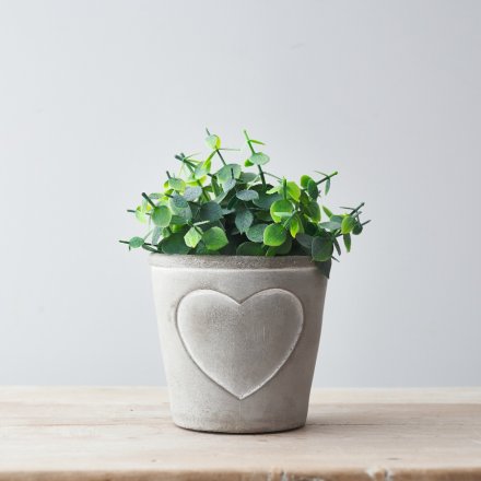 A rustic grey and white pot planter with an embossed heart design.