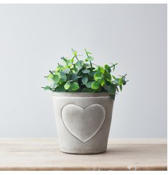 A rustic grey and white pot planter with an embossed heart design.