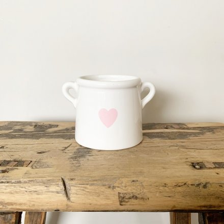 A shabby chic style pot planter with handles. Complete with a pretty pink heart decal.