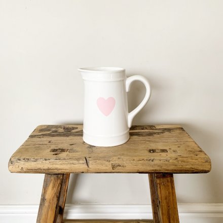 A chic white ceramic jug with a pretty in pink heart shaped design.