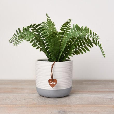A contemporary grey and white ribbed planter with a PU Leather love tag.