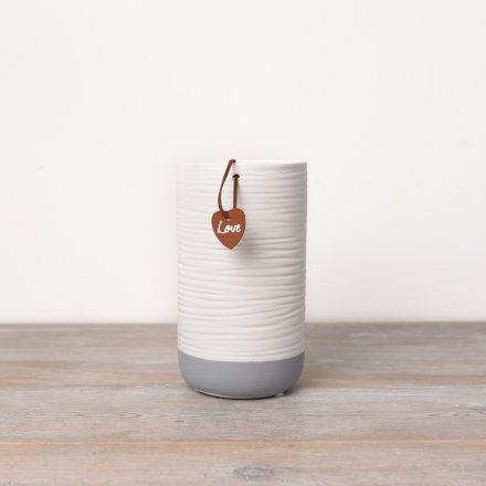 A classic white and grey coloured vase complete with a faux leather heart shaped tag which reads 'love'