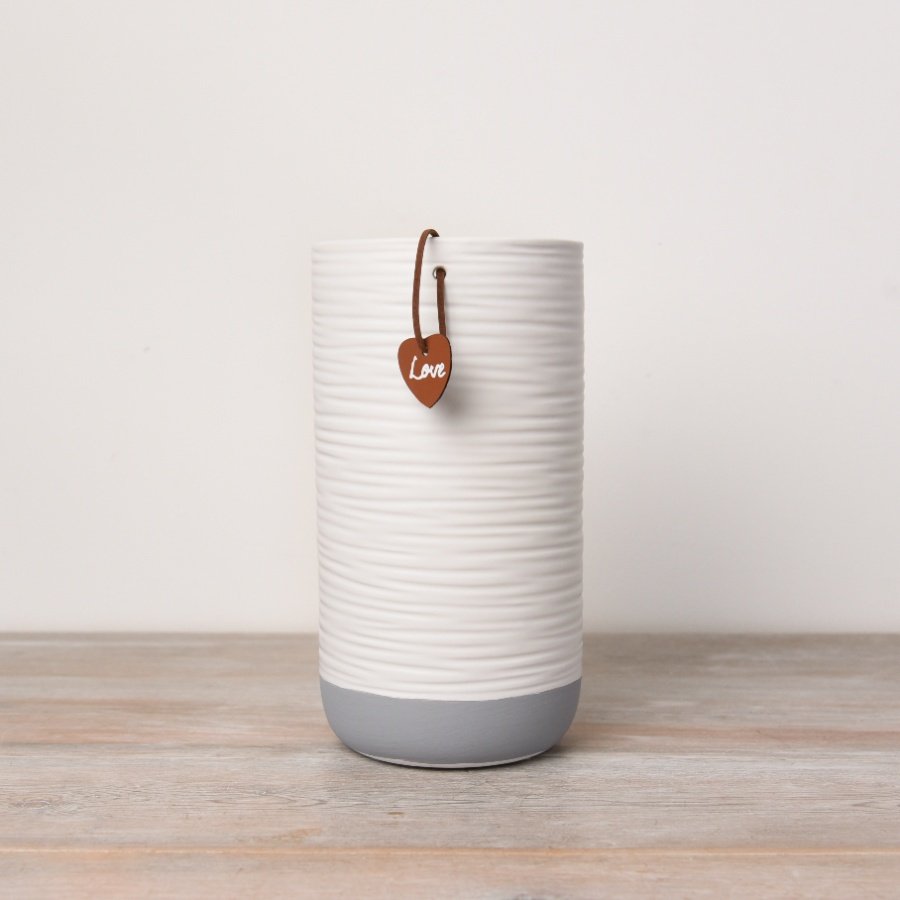 A stylish and contemporary white and grey vase with a textured surface finish. 