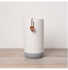A stylish and contemporary white and grey vase with a textured surface finish. 