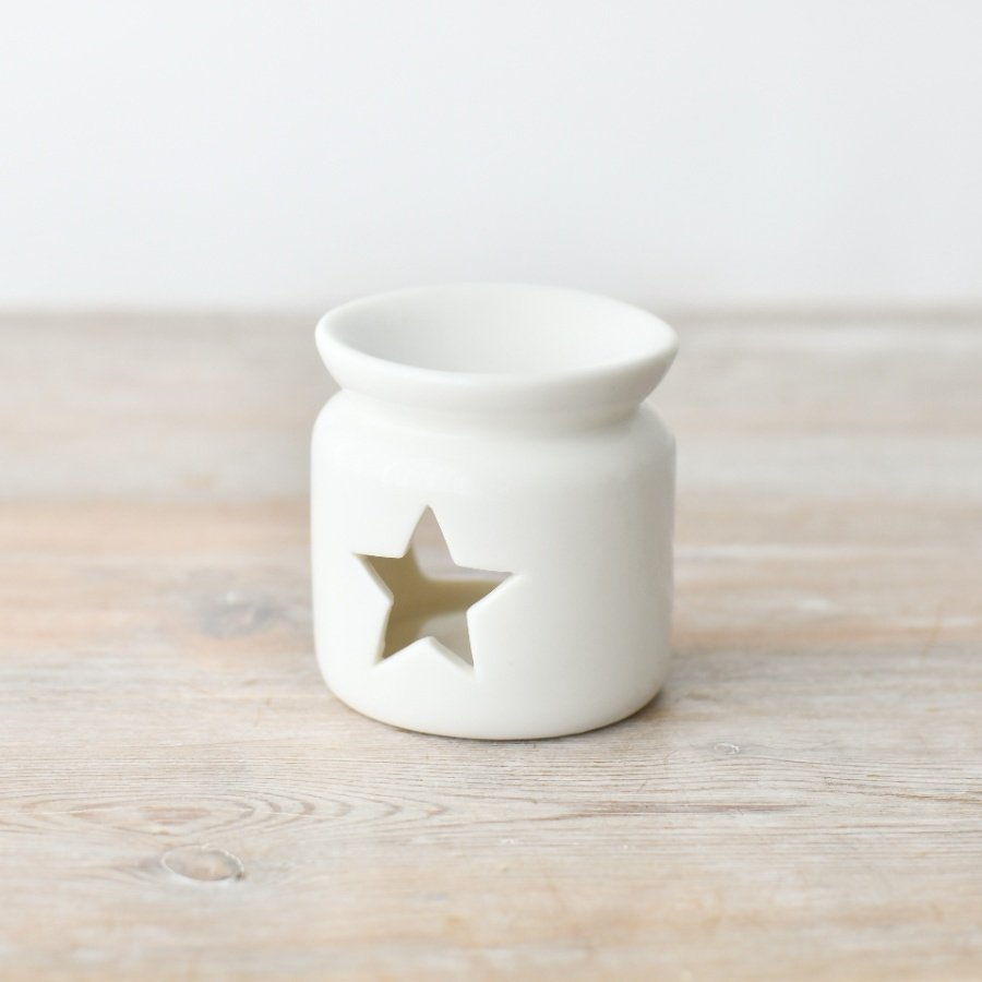 A chic and stylish oil burner in white, complete with a star shaped cut out design.