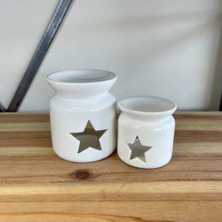 A White ceramic oil burner with a stylish star shaped cut out design.
