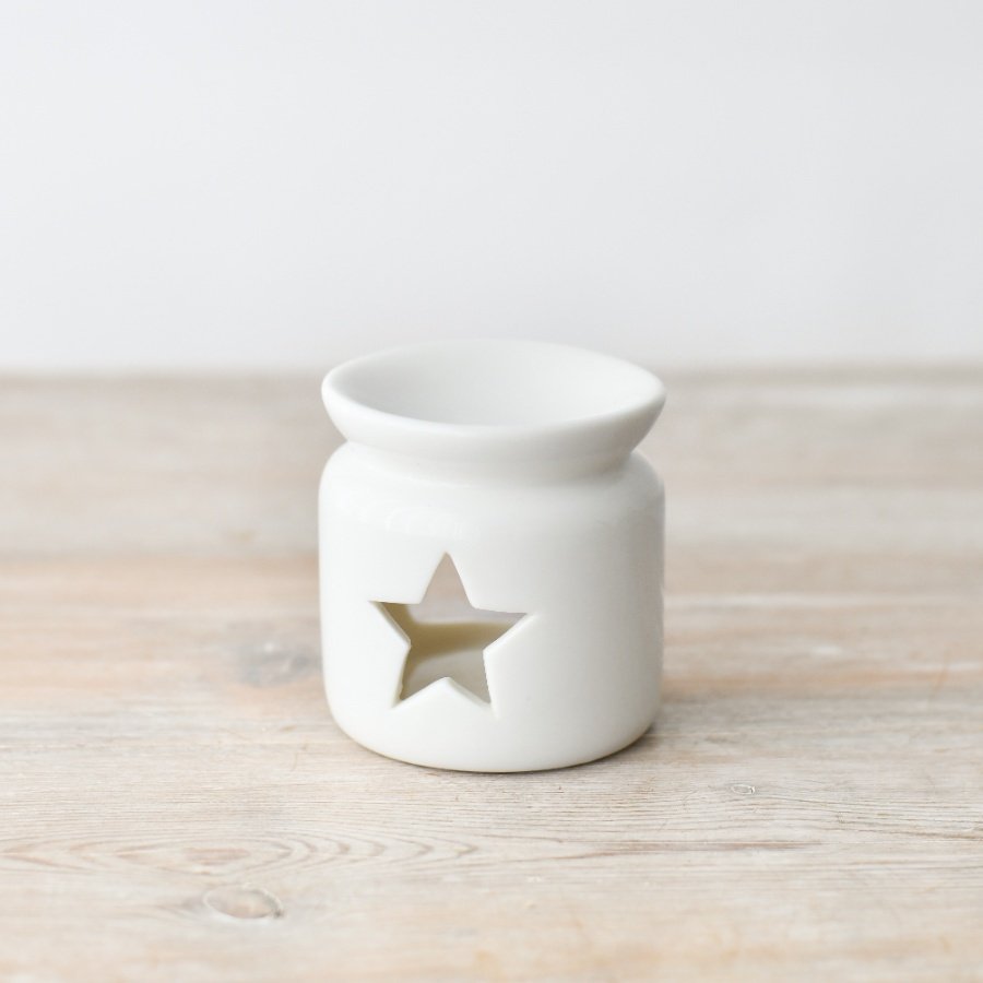 A chic and stylish ceramic oil burner in white. Complete with a star shaped cut out design.