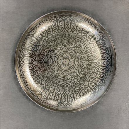   A Luxury themed iron based bowl decorated with a silver tone and embossed feather decal 