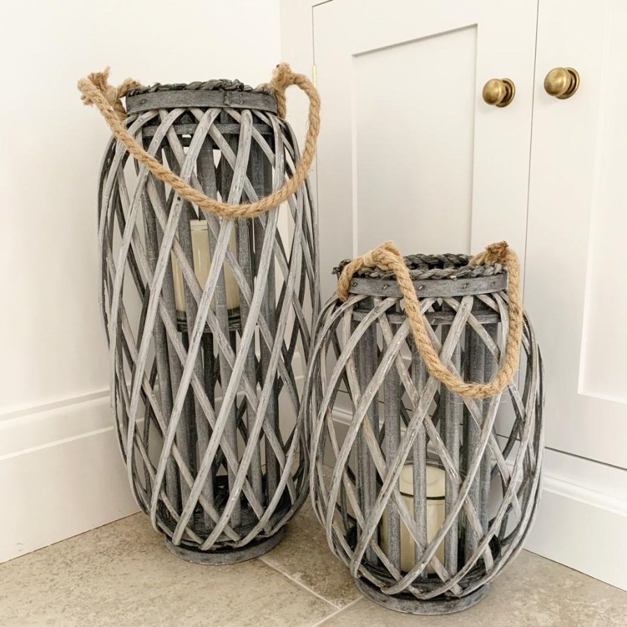 A large grey woven lantern with rope handle