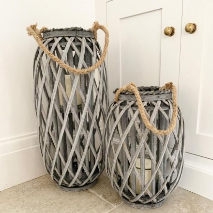 A tall grey woven lantern with chunky rope handle