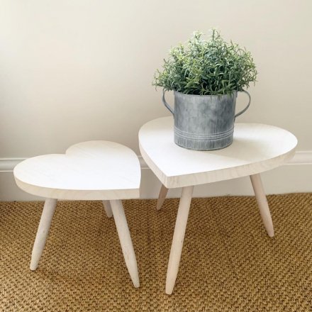   A large sized heart shaped stool complete with a smooth natural wooden feature. 
