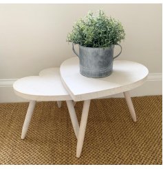  A large sized heart shaped side table complete with a smooth natural wooden feature.