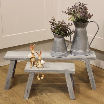 A set of 2 charming wooden potting benches. Each has a washed, distressed finish and is perfectly sized