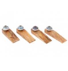 An assortment of wooden wedge doorstops, each decorated with a pretty white and blue peacock decorated knob 
