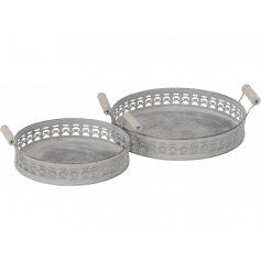 A set of 2 rustic round metal trays with a stylish pattern. Complete with wooden carry handles.