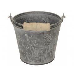 A rustic metal bucket with wooden carry handle. Decorated with a stunning wild flower design.