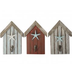 An assortment of 3 rustic wooden beach huts. Each has a starfish decoration and a distressed metal hook.