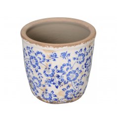 A vintage inspired stoneware planter with a brilliant blue floral motif.