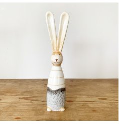 A charming ceramic bunny with a rustic finish. Complete with a chic stripe outfit and pointed ears.