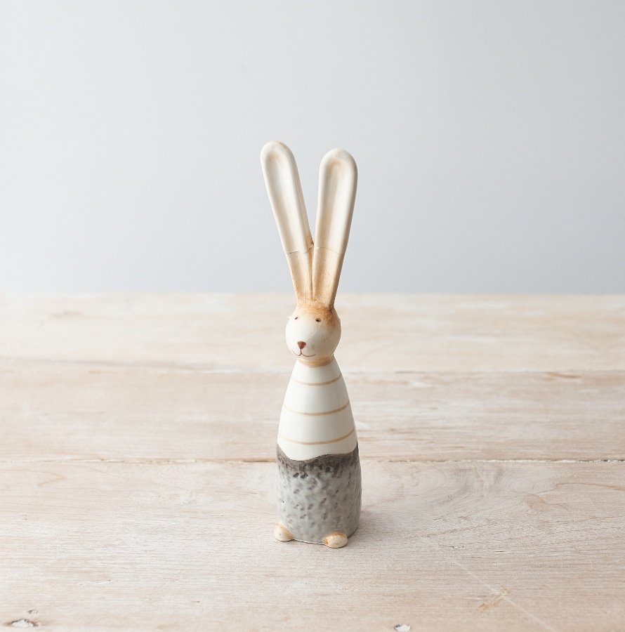 A charming ceramic bunny decoration with a rustic and textured finish. Complete with pointy ears.