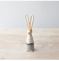 A charming ceramic bunny decoration with a rustic and textured finish. Complete with pointy ears.