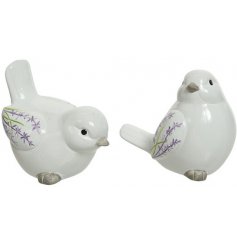 An assortment of posed terracotta birds with a white glaze finish and charmingly simple lavender embossment 
