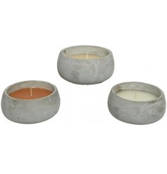 An assortment of 3 beautifully coloured citronella candles set within on trend cement pots.