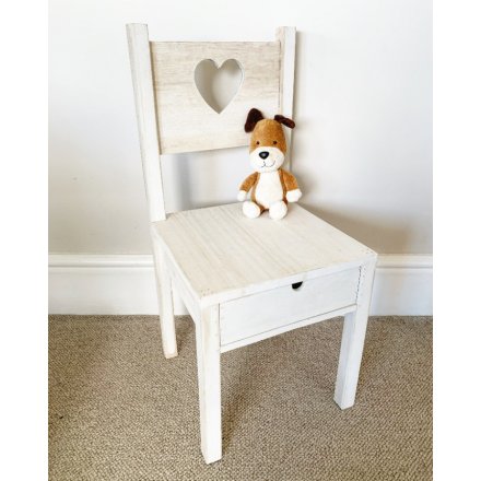 A charming wooden chair with a heart cut out design and pull out drawer.