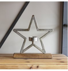 A charming and rustic inspired aluminium star ornament on a natural wooden block base 