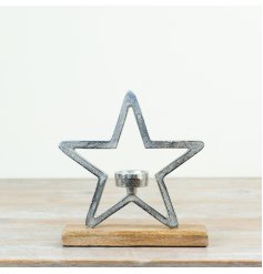 A charming and rustic inspired aluminium star ornament on a natural wooden block base 