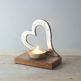 A charming and rustic inspired aluminium heart ornament on a natural wooden block base 