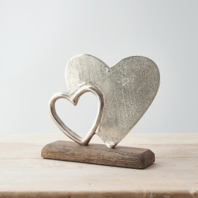  A simple and rustic-inspired wooden decoration with an added aluminium double heart display on it 