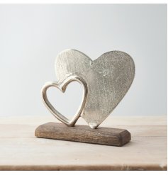  A simple and rustic-inspired wooden decoration with an added aluminium double heart display on it 