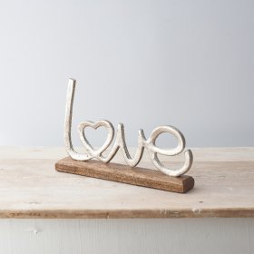 Sure to bring a charming country vibe to any hallway or home space , a decorative Love Sign with a rustic edge and natur