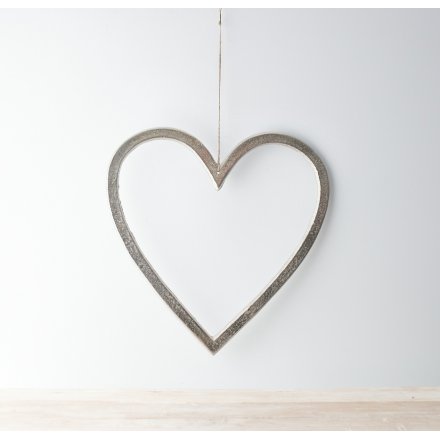 A rough luxe inspired heart decoration with a textured silver aluminium finish. Complete with a long jute string hanger.
