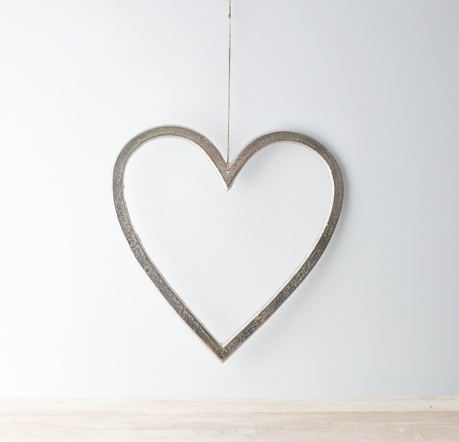 A large and simplistic ornamental heart set with a distressed feature and jute string hanger 