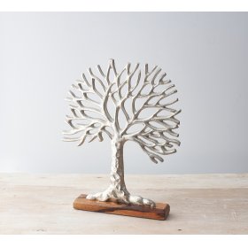 a silver toned aluminium tree of life ornament on a block wooden base 