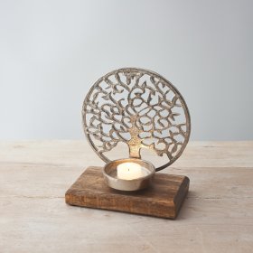 A beautiful aluminium tree of life ornament set upon a wooden block base