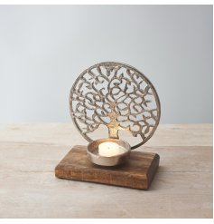  a tree of life decorated candle holder on a wooden block base 