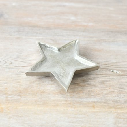   A small aluminium star shaped trinket dish with an overly distressed finish 