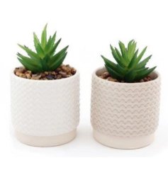 An assortment of natural toned candle pots, each set with a ridged embossed finish and neutral colour tones